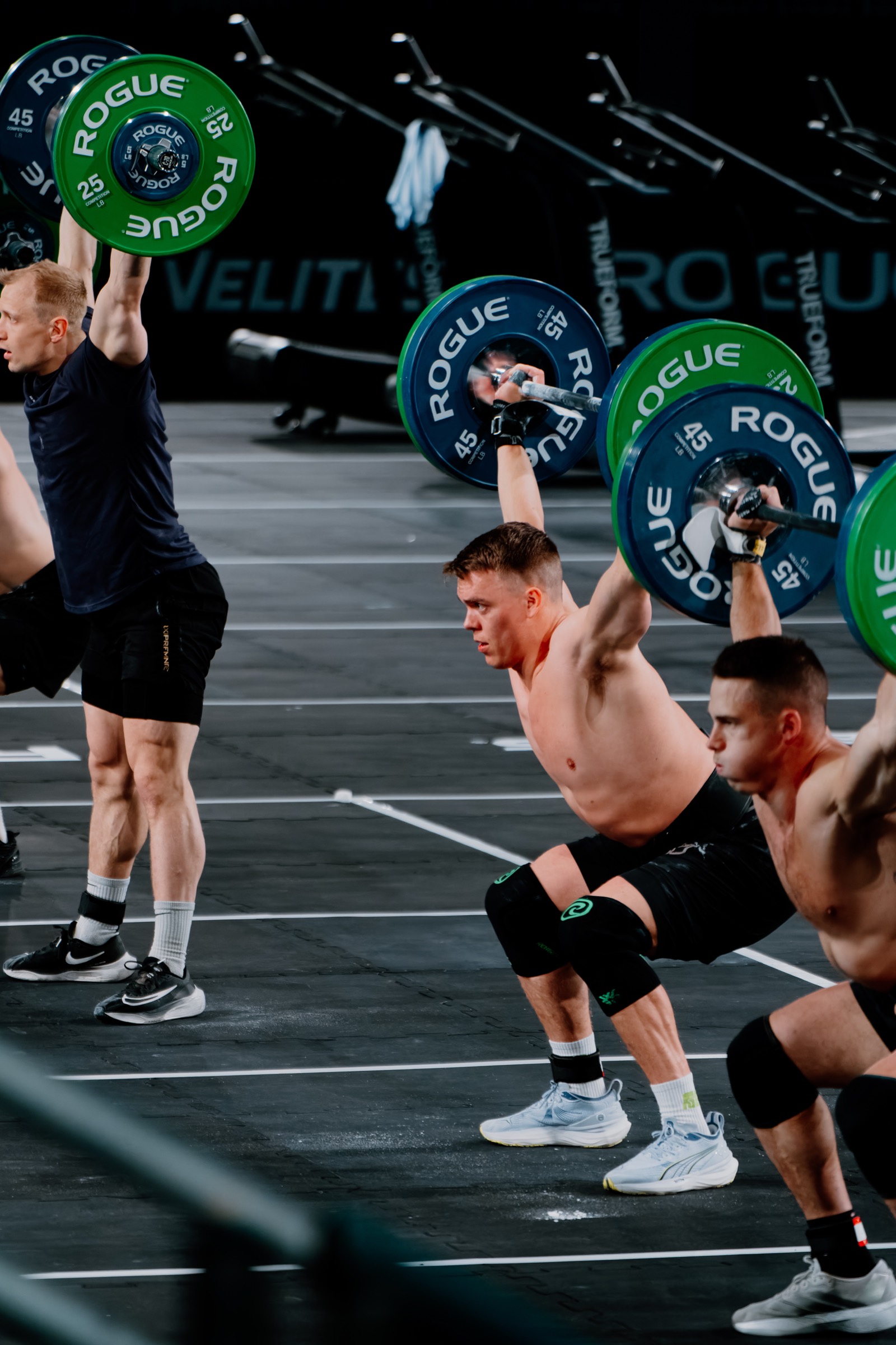 Kriger athletes receiving snatches overhead on the competition floor